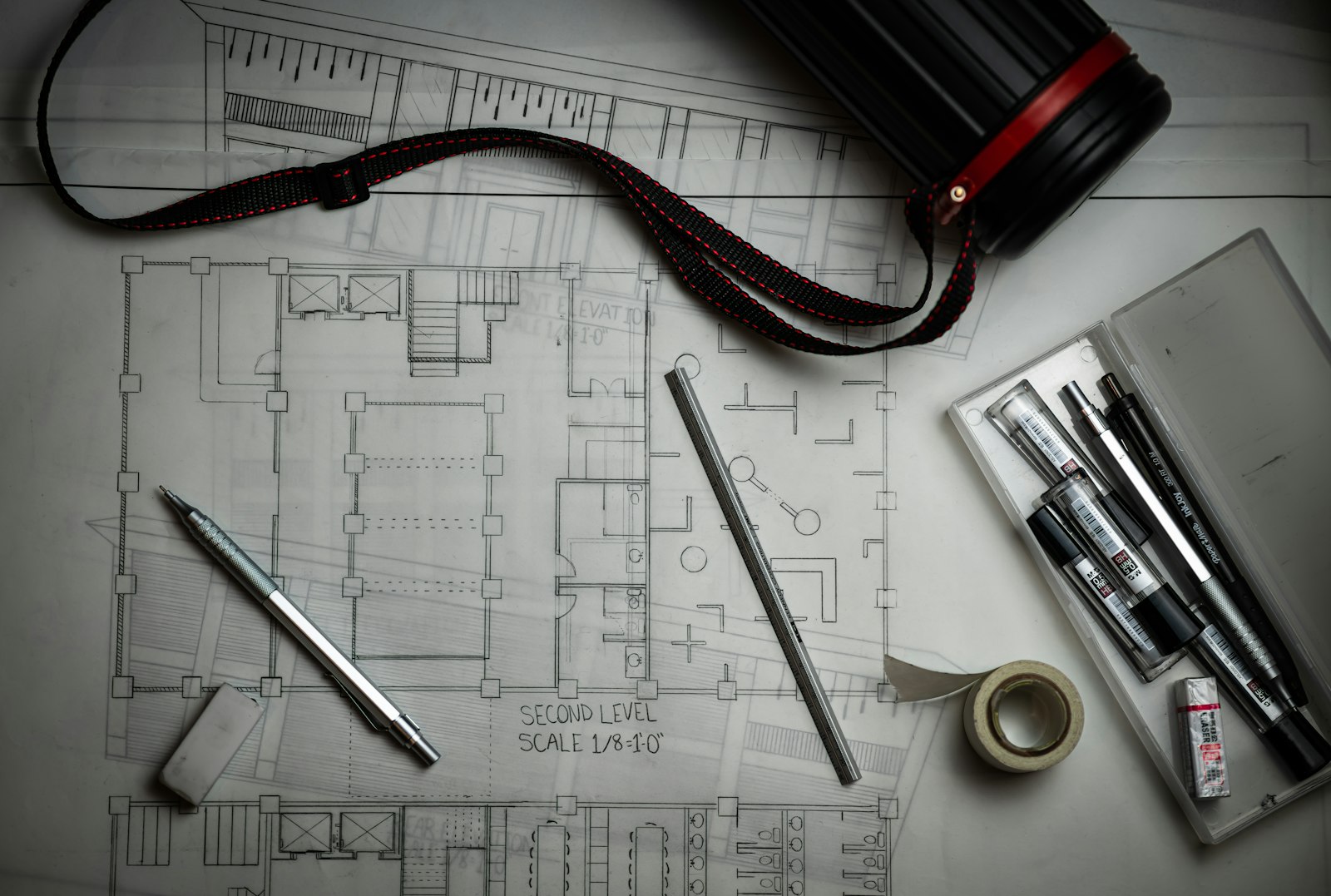 Architectural drawings and drafting tools on a table
